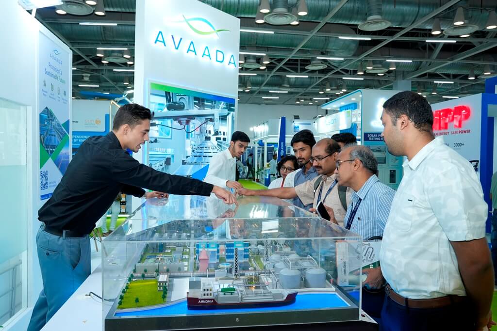 explaining sustainable energy solutions to visitors at the REI Expo